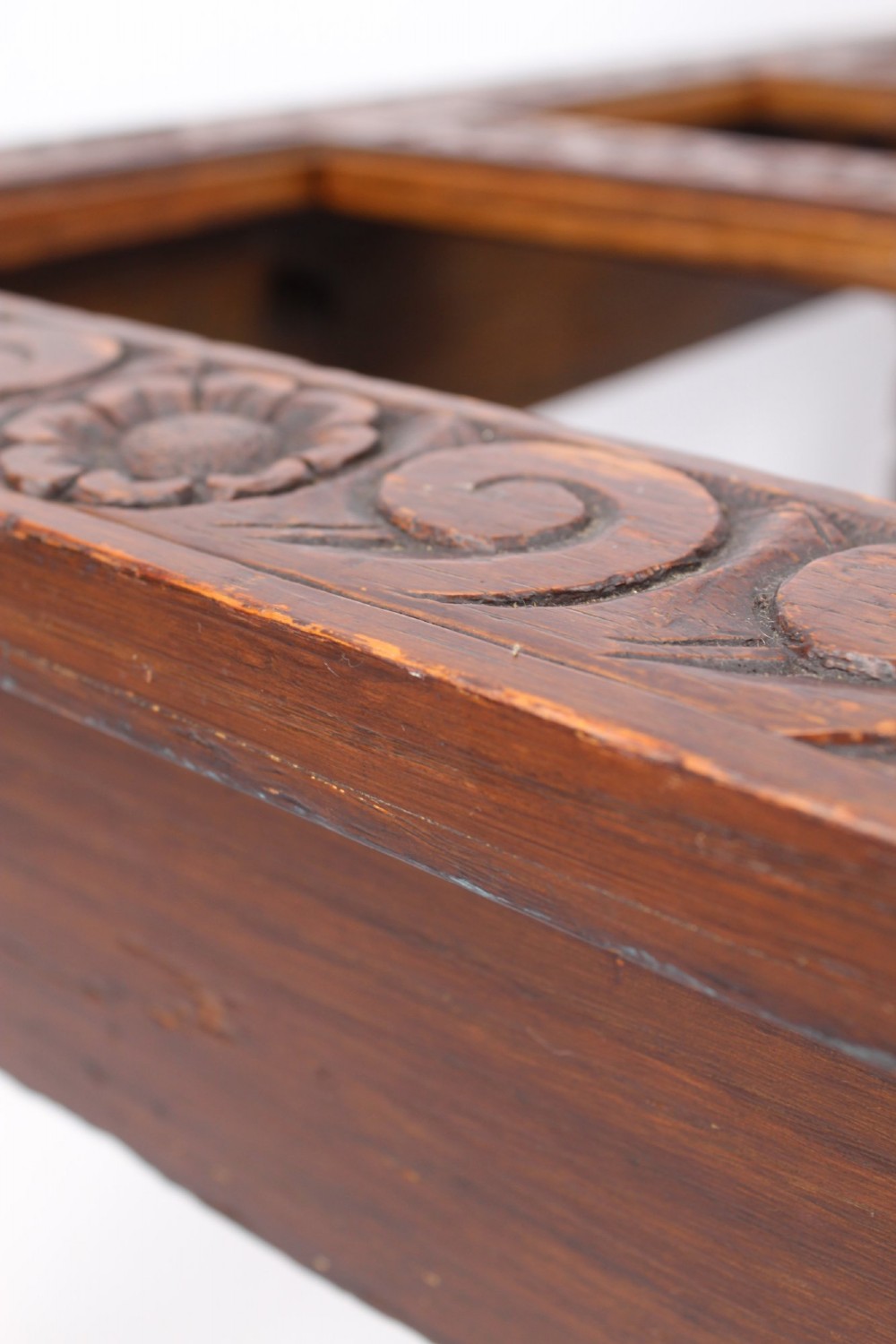 An Edwardian carved oak luggage stand with relief floral carving along the open top frame and turned wooden legs. View XII
