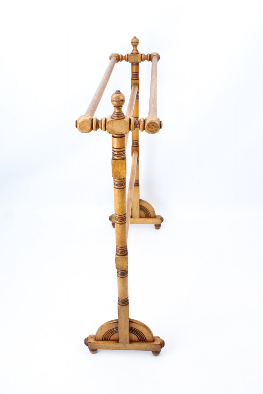 A Victorian ash freestanding towel rail featuring four horizontal bars, turned side columns with finials, and carved pedestal feet. View IV