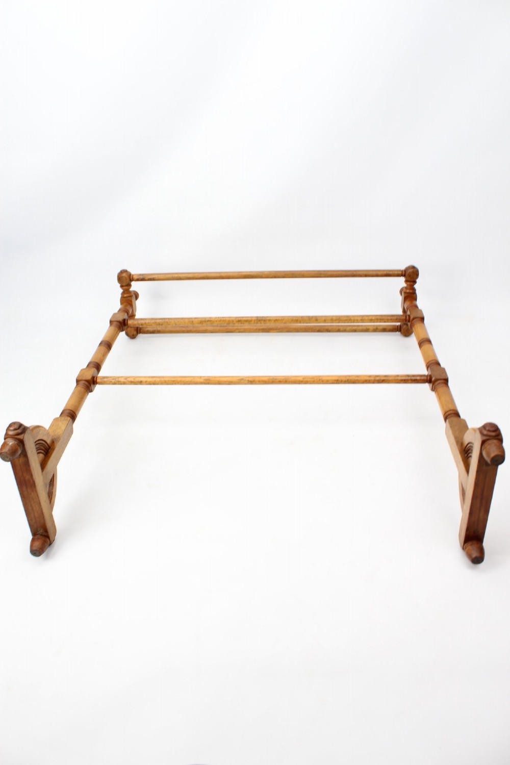 A Victorian ash freestanding towel rail featuring four horizontal bars, turned side columns with finials, and carved pedestal feet. View XI