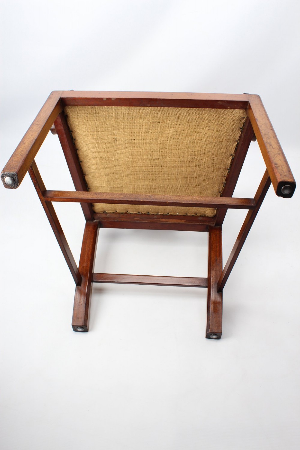 An Edwardian Chippendale style mahogany desk chair with a pierced carved back splat, curved armrests, and a patterned tapestry seat. View XII