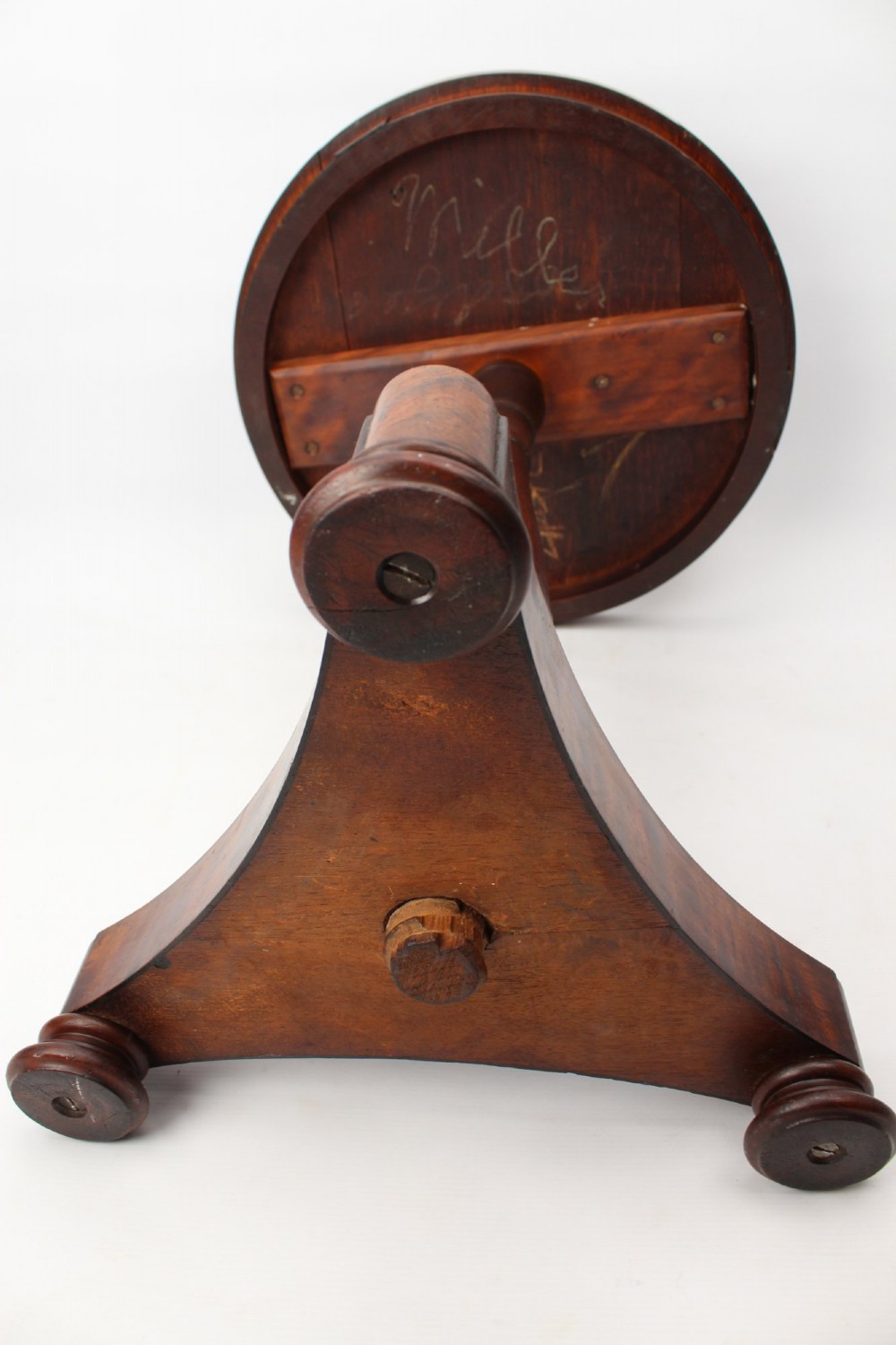 A circular mahogany wine table from the William IV period featuring a turned central column on a triform base with flattened bun feet. View XII