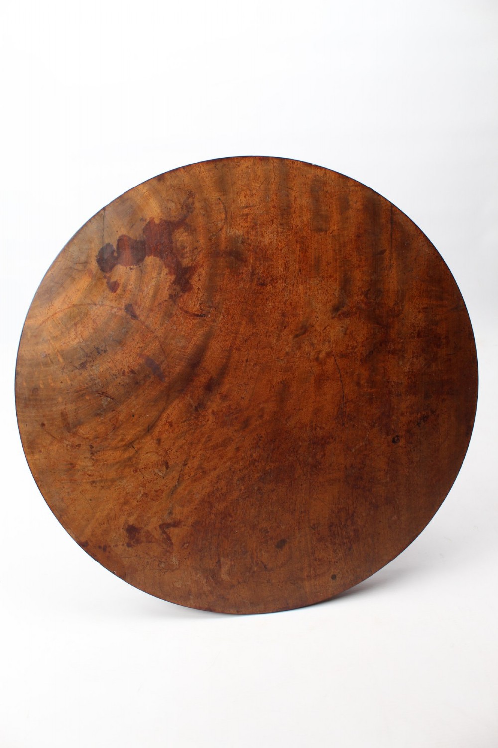 A circular mahogany wine table from the William IV period featuring a turned central column on a triform base with flattened bun feet. View XIII