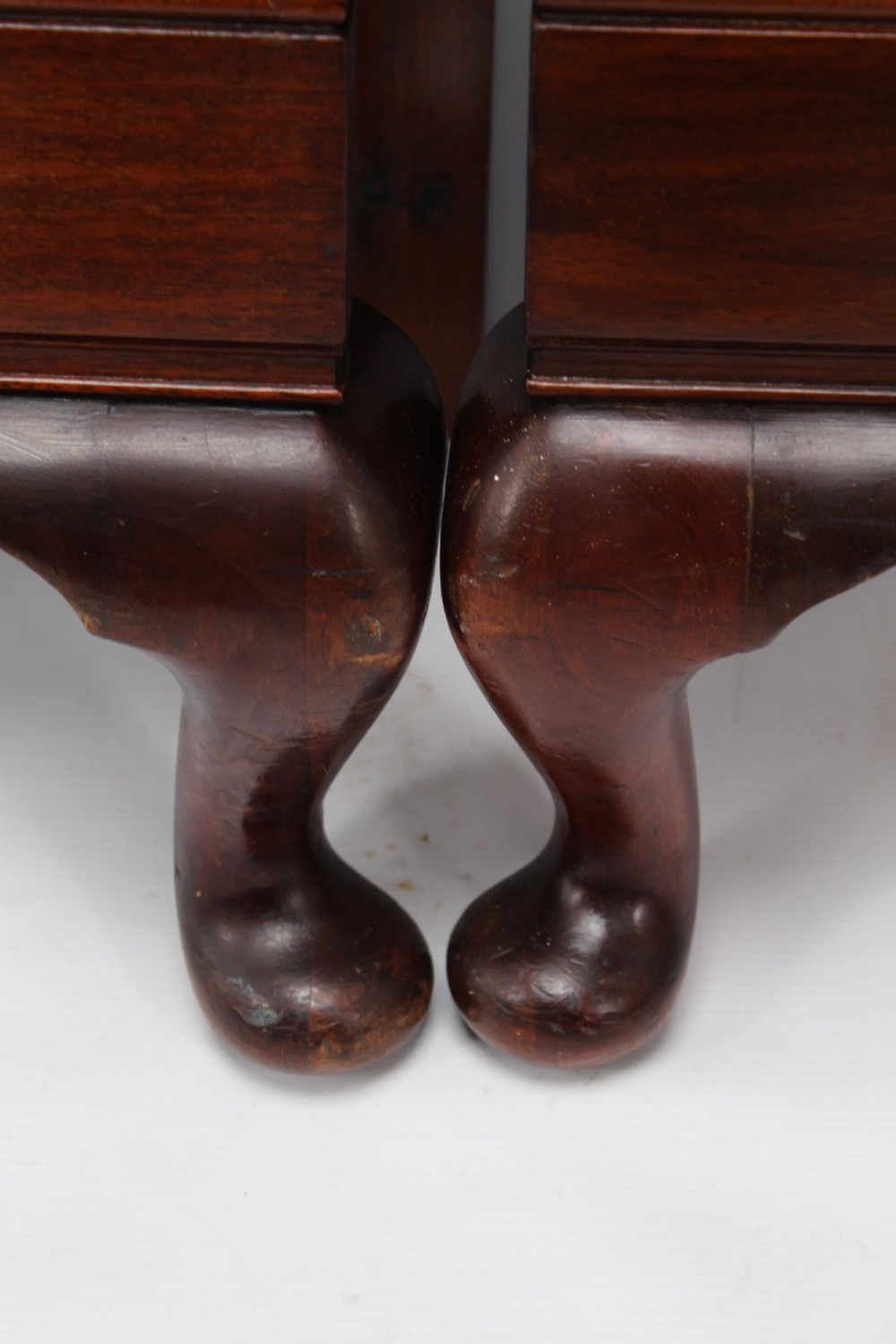 A matching pair of Art Deco mahogany single beds with stepped, arched headboards and low footboards on short cabriole feet. View V