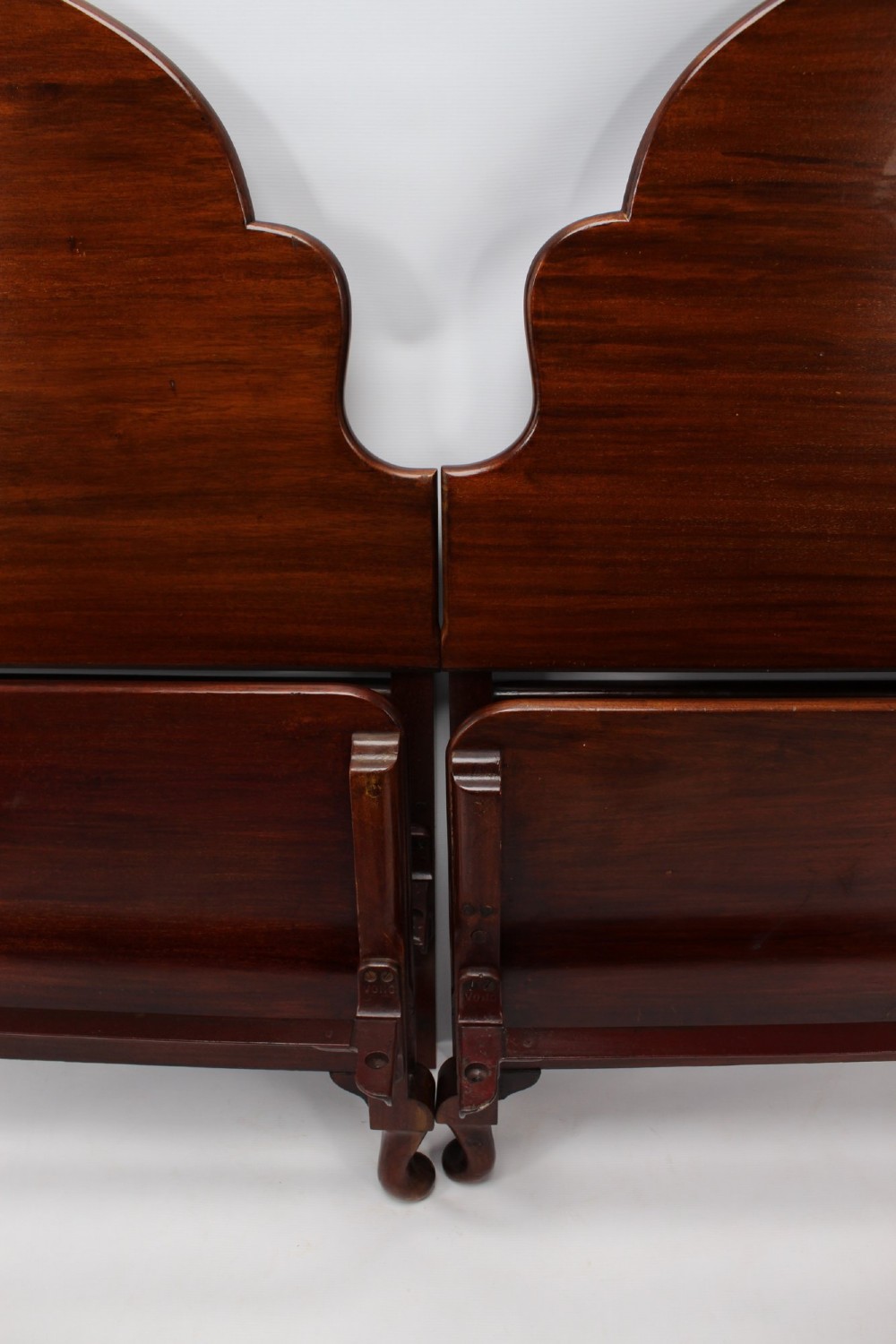 A matching pair of Art Deco mahogany single beds with stepped, arched headboards and low footboards on short cabriole feet. View VII