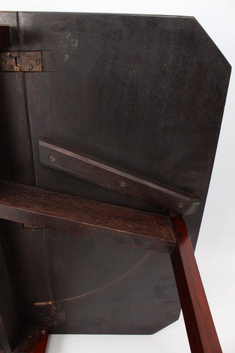 A compact Edwardian mahogany Sutherland table with folded side leaves, slatted end supports, and legs fitted with brass castors. View XIII
