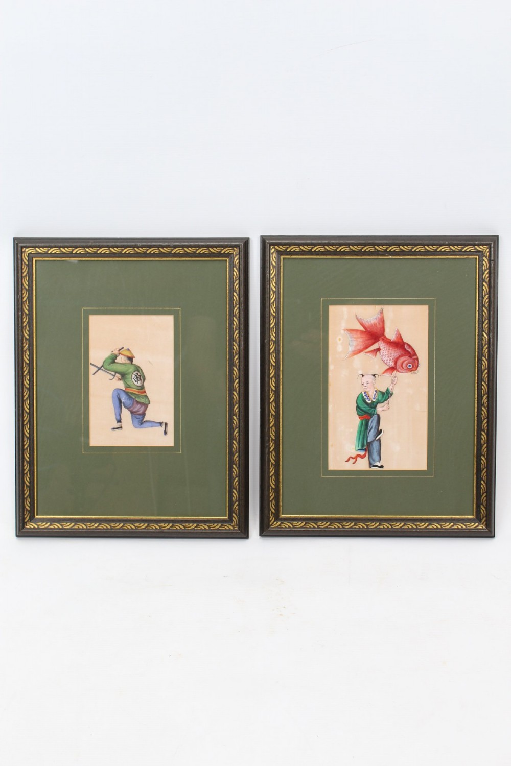 A pair of small framed antique Chinese watercolour paintings on pith paper, set in dark green mounts with gilded decorative frames.