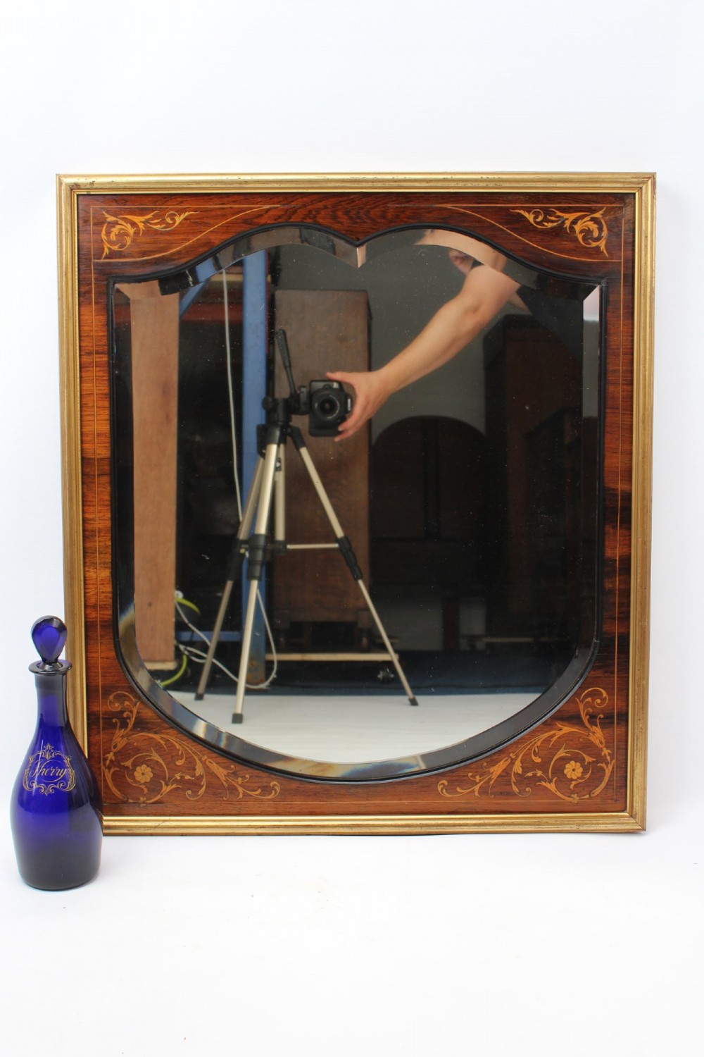 A rectangular rosewood wall mirror featuring gilt outer moulding, floral corner marquetry inlays, and an arched bevelled glass plate. View II