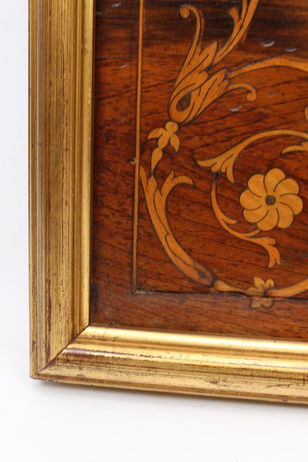 A rectangular rosewood wall mirror featuring gilt outer moulding, floral corner marquetry inlays, and an arched bevelled glass plate. View VIII