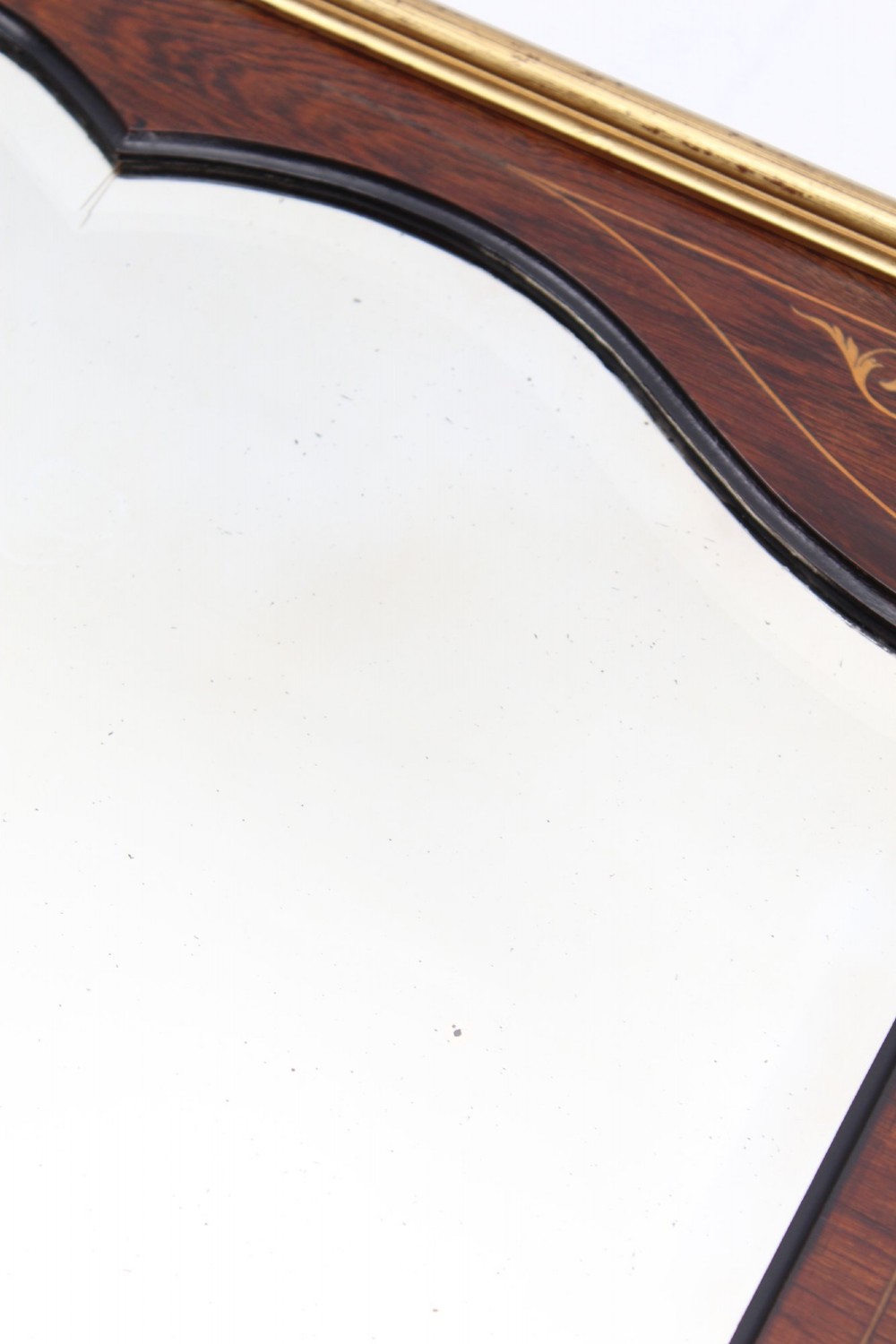 A rectangular rosewood wall mirror featuring gilt outer moulding, floral corner marquetry inlays, and an arched bevelled glass plate. View XIII