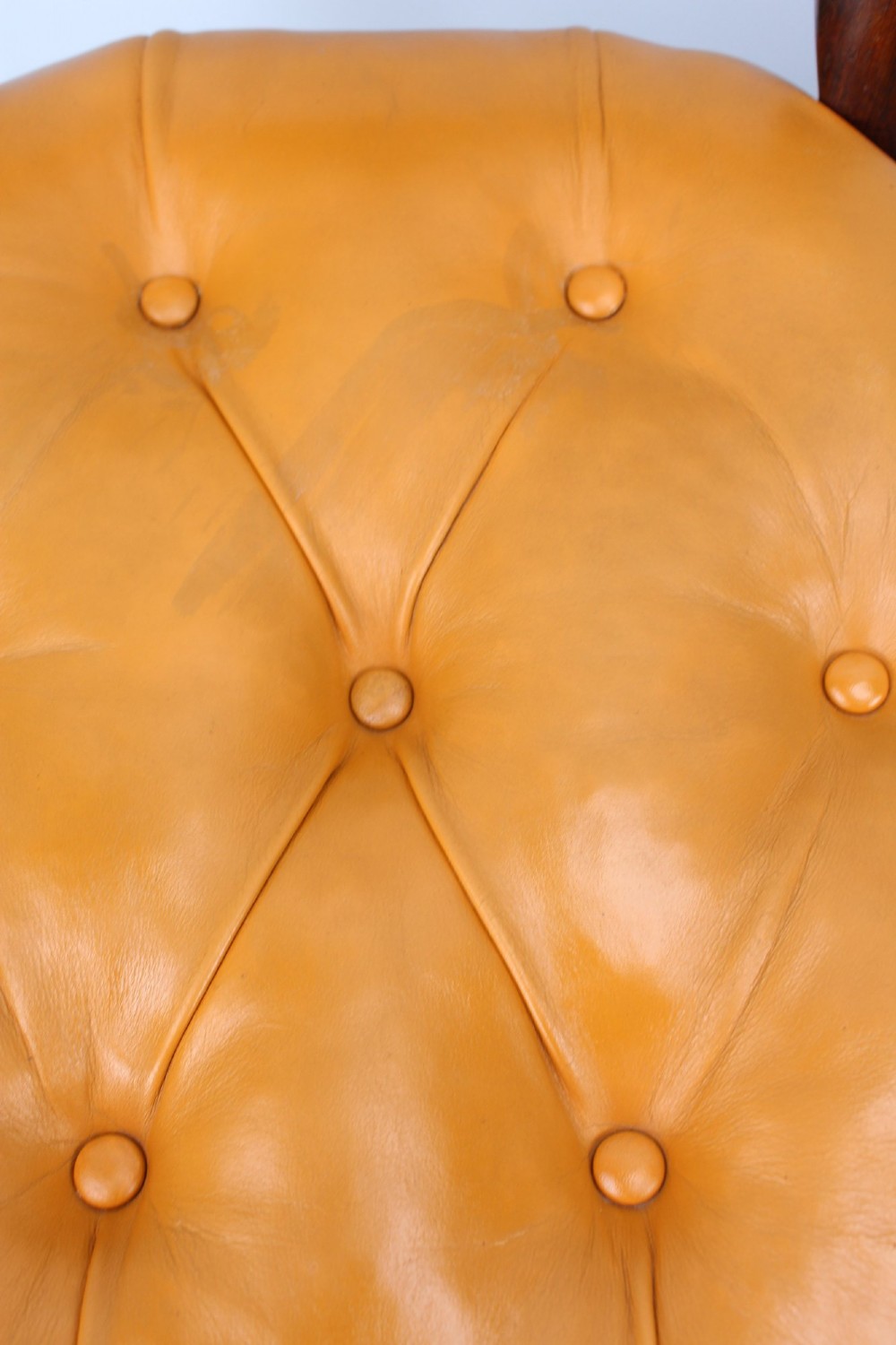 A pair of Victorian rosewood balloon back side chairs featuring button-tufted tan leather upholstery and cabriole front legs. View VII