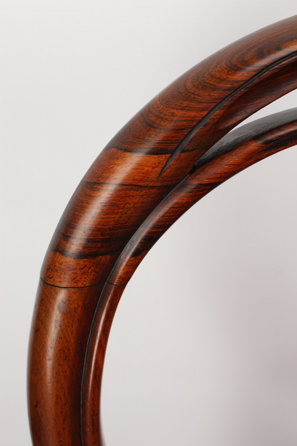 A pair of Victorian rosewood balloon back side chairs featuring button-tufted tan leather upholstery and cabriole front legs. View VIII
