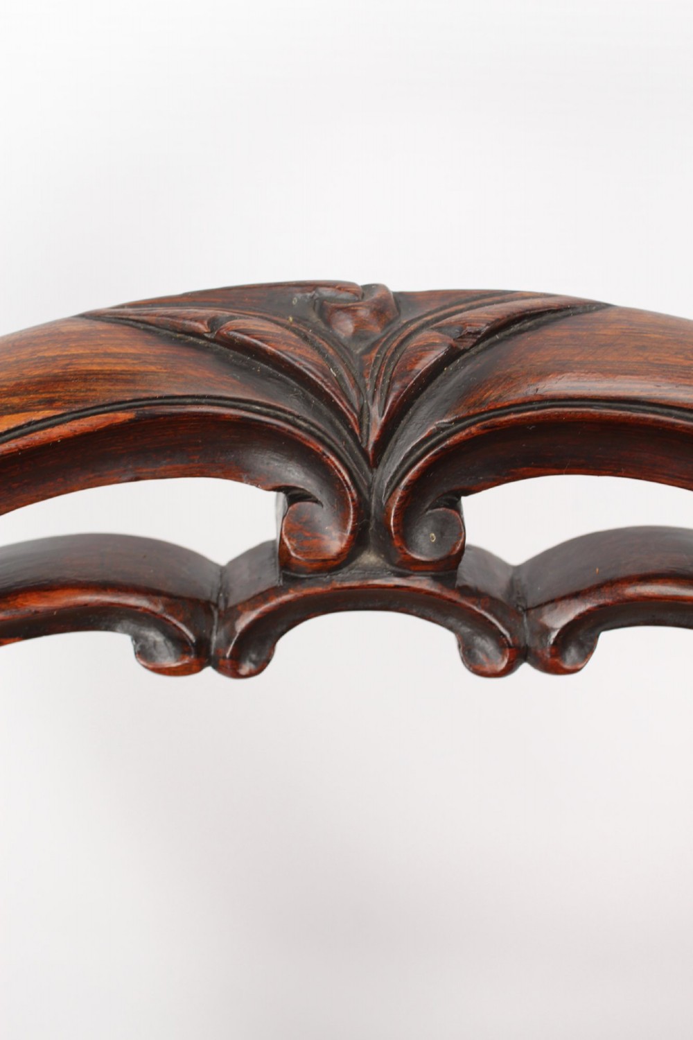 A pair of Victorian rosewood balloon back side chairs featuring button-tufted tan leather upholstery and cabriole front legs. View IX
