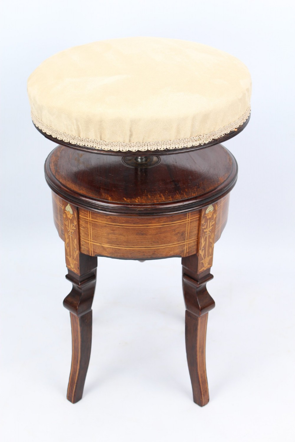 A circular padded beige stool on a dark rosewood base featuring floral marquetry and curved legs. View III