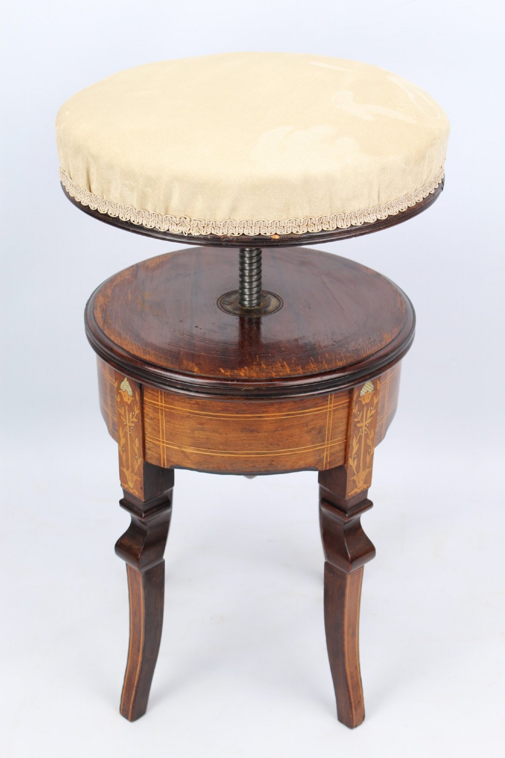 A circular padded beige stool on a dark rosewood base featuring floral marquetry and curved legs. View IV