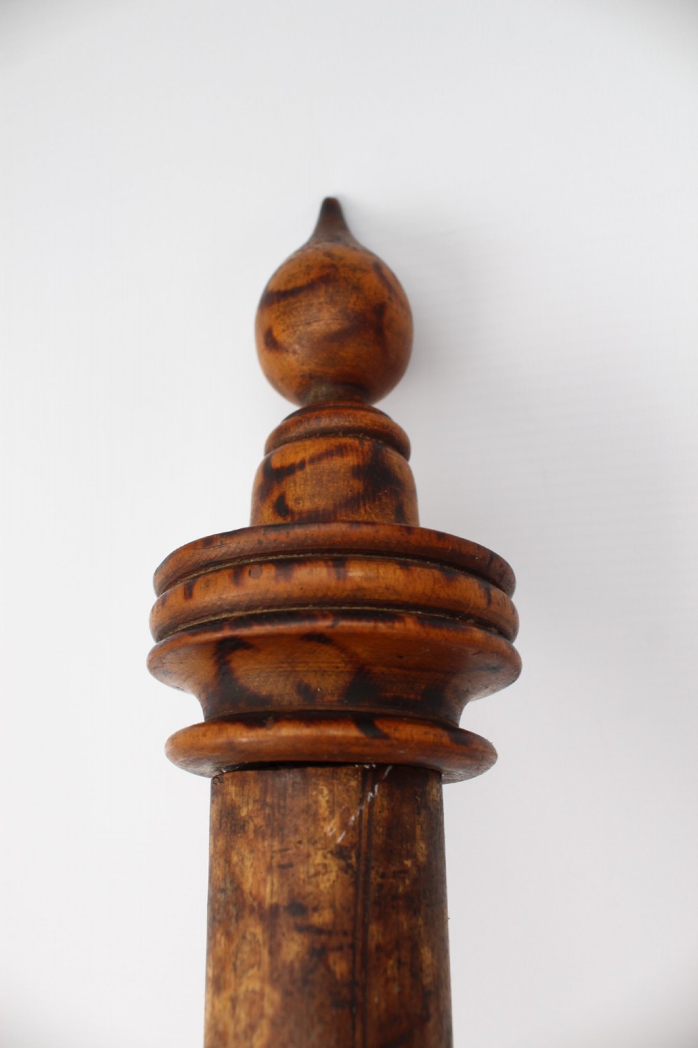 A long natural bamboo curtain pole featuring turned wooden finials at both ends and a set of matching wooden curtain rings stacked near one end. View IV