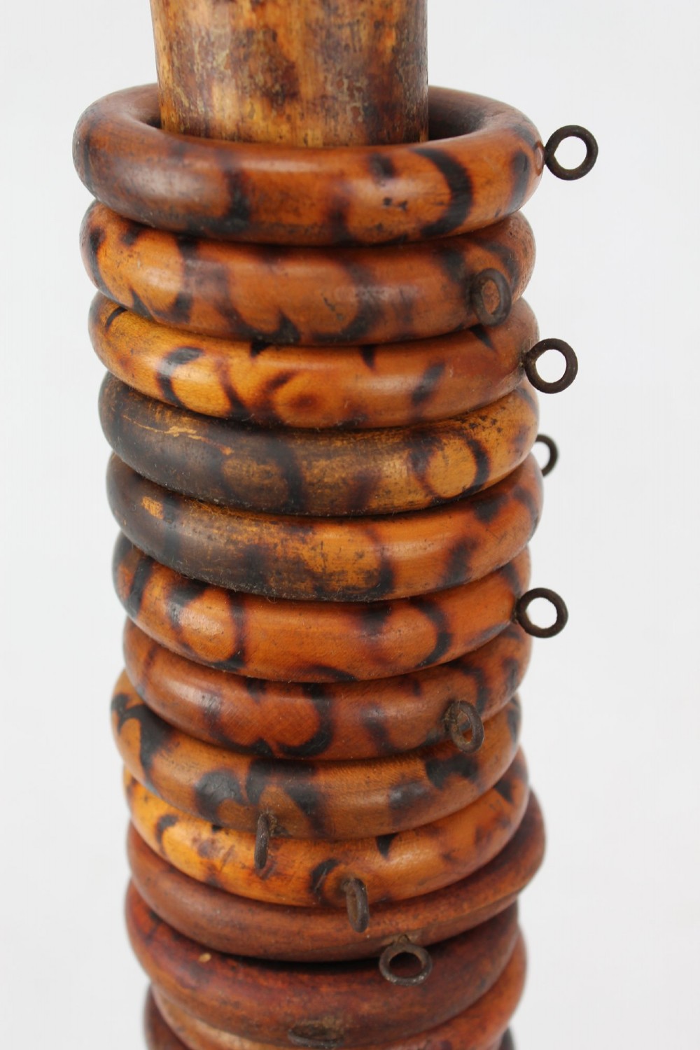 A long natural bamboo curtain pole featuring turned wooden finials at both ends and a set of matching wooden curtain rings stacked near one end. View VI