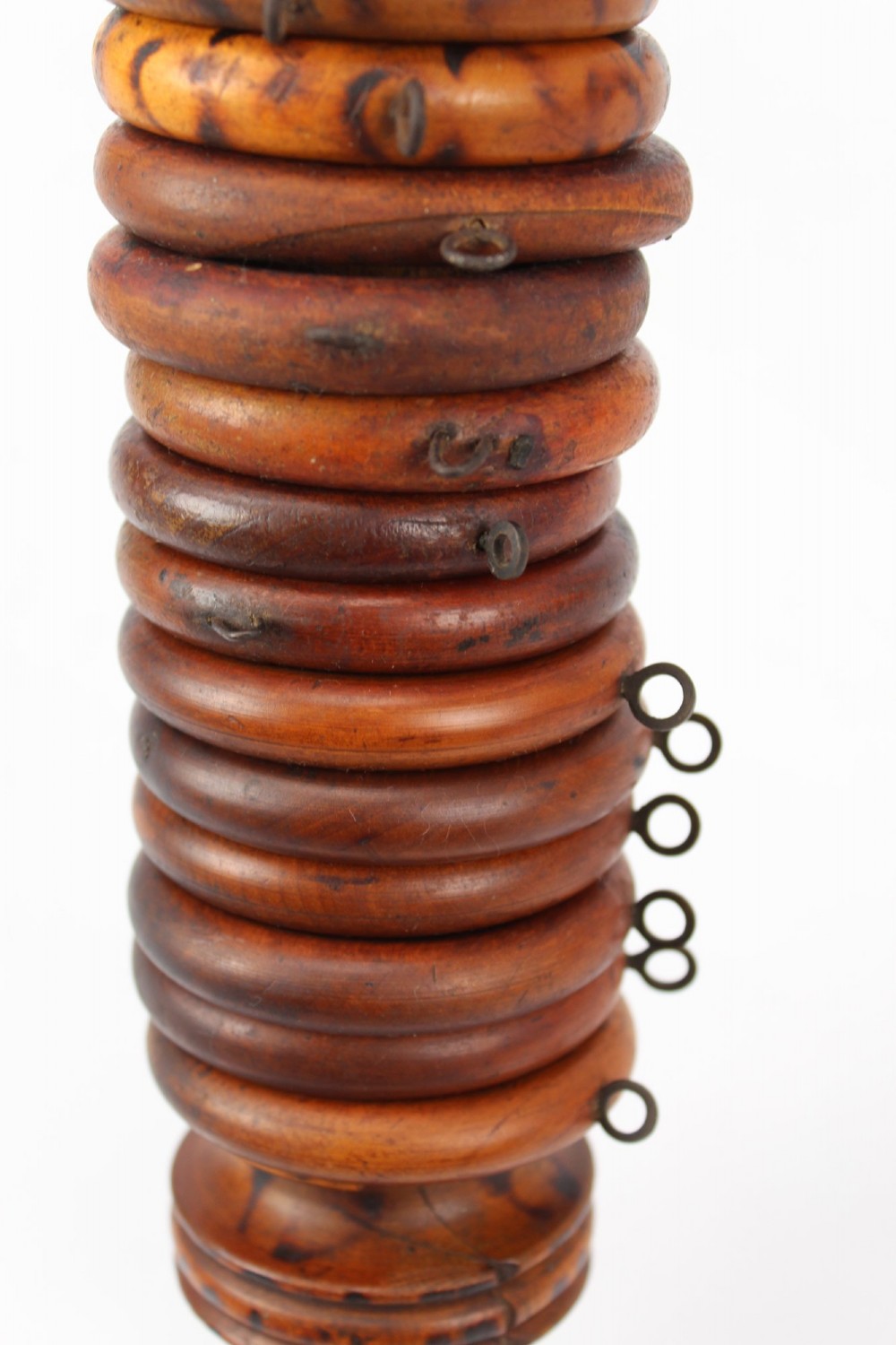 A long natural bamboo curtain pole featuring turned wooden finials at both ends and a set of matching wooden curtain rings stacked near one end. View VII