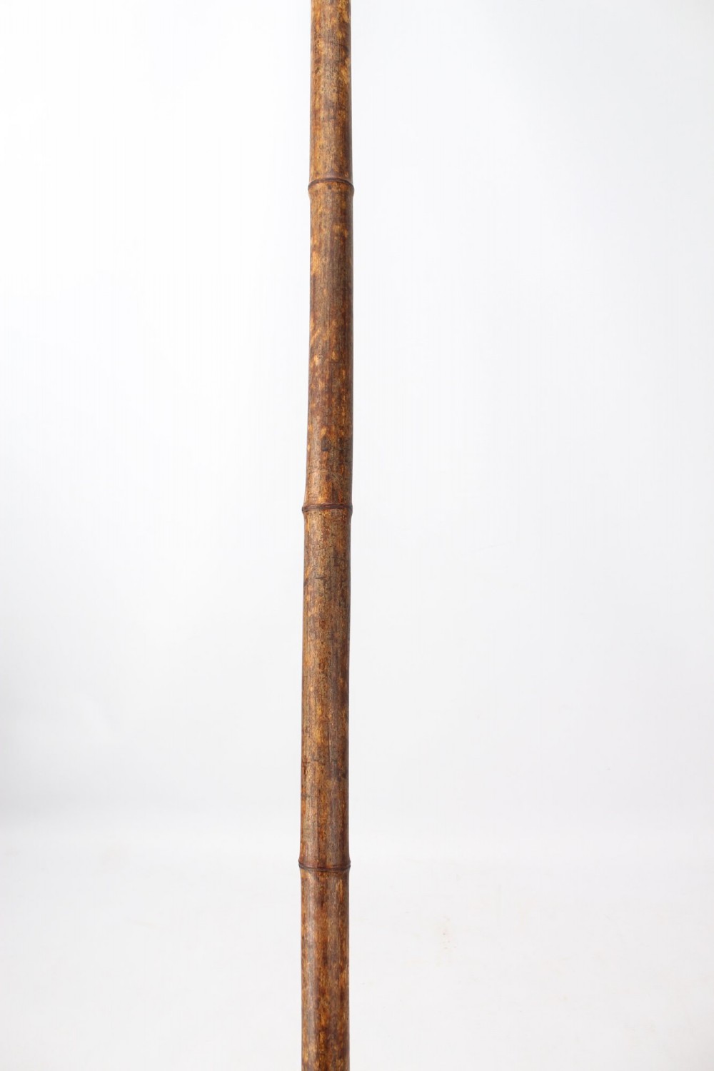 A long natural bamboo curtain pole featuring turned wooden finials at both ends and a set of matching wooden curtain rings stacked near one end. View VIII