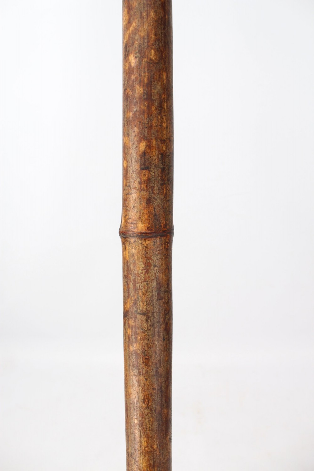 A long natural bamboo curtain pole featuring turned wooden finials at both ends and a set of matching wooden curtain rings stacked near one end. View IX