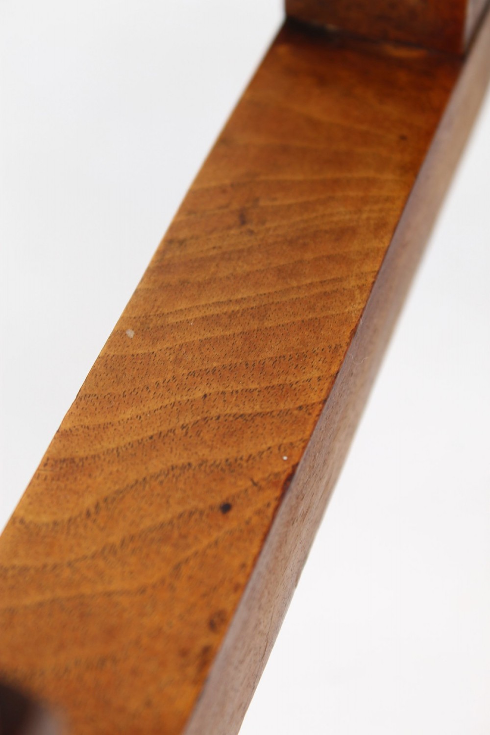 A Victorian burr walnut oval table shown with its top tilted vertically on a wooden frame with turned legs. View IX