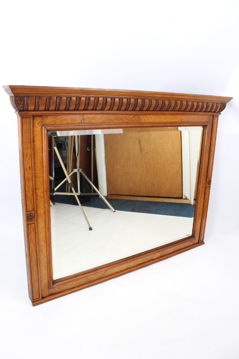 A large rectangular Victorian oak overmantel mirror featuring a moulded frame with a fluted frieze top cornice and carved side rosettes. View II