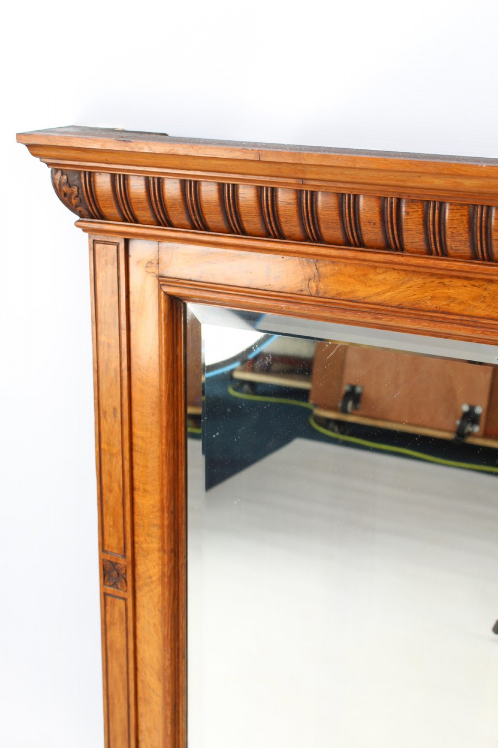 A large rectangular Victorian oak overmantel mirror featuring a moulded frame with a fluted frieze top cornice and carved side rosettes. View III
