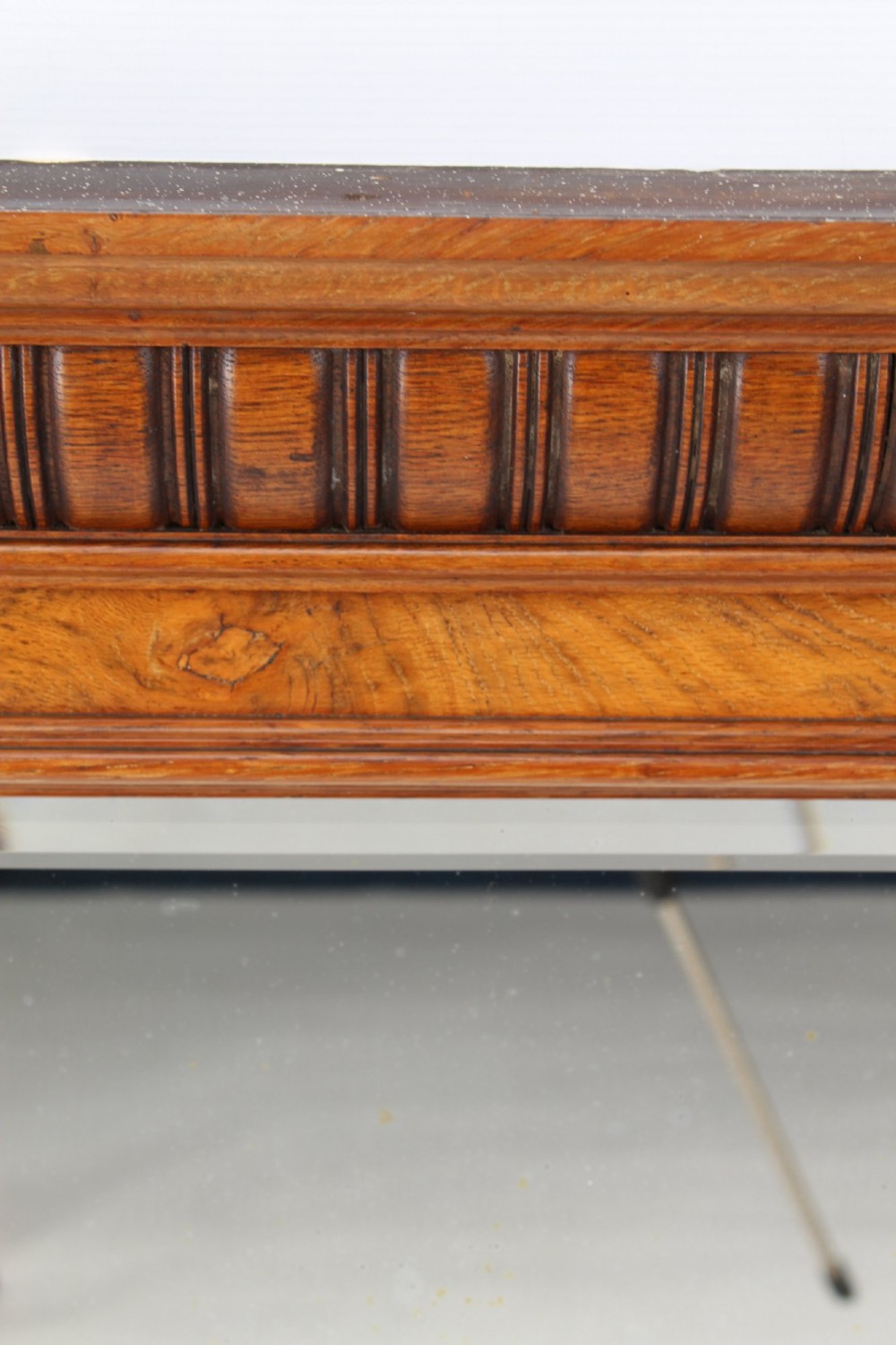 A large rectangular Victorian oak overmantel mirror featuring a moulded frame with a fluted frieze top cornice and carved side rosettes. View V