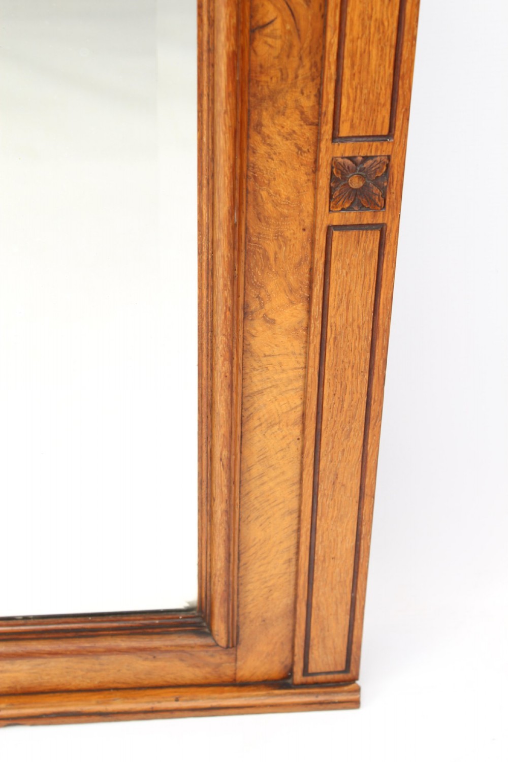 A large rectangular Victorian oak overmantel mirror featuring a moulded frame with a fluted frieze top cornice and carved side rosettes. View VI