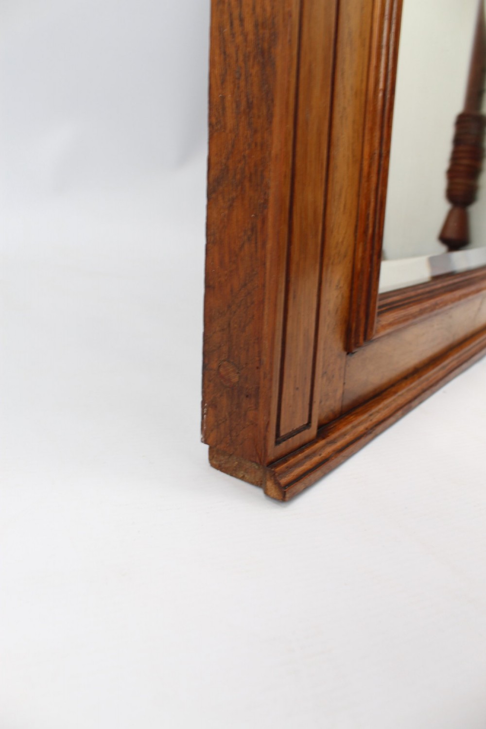 A large rectangular Victorian oak overmantel mirror featuring a moulded frame with a fluted frieze top cornice and carved side rosettes. View IX