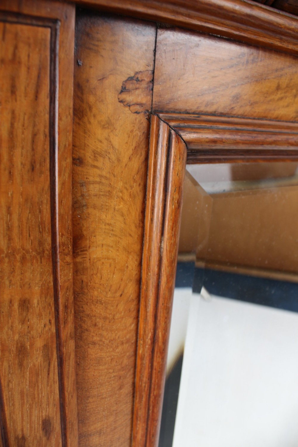 A large rectangular Victorian oak overmantel mirror featuring a moulded frame with a fluted frieze top cornice and carved side rosettes. View X