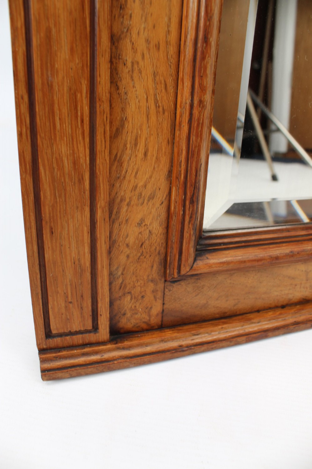 A large rectangular Victorian oak overmantel mirror featuring a moulded frame with a fluted frieze top cornice and carved side rosettes. View XI