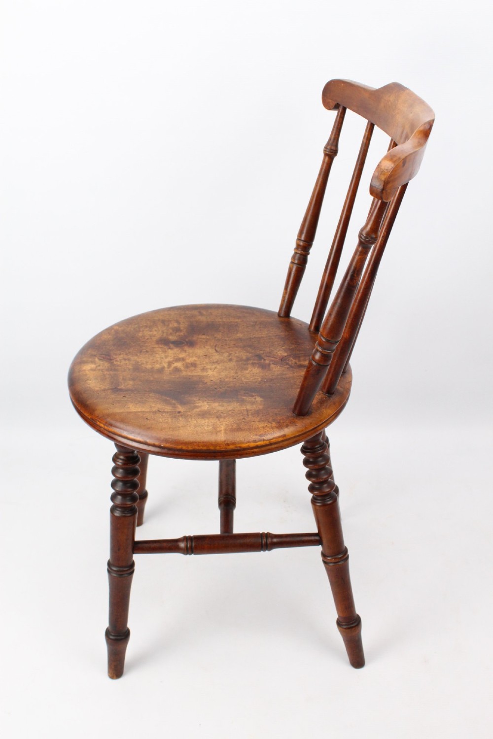 A pair of warm brown wooden kitchen chairs featuring spindle backs, turned legs, and solid timber seats. View IV