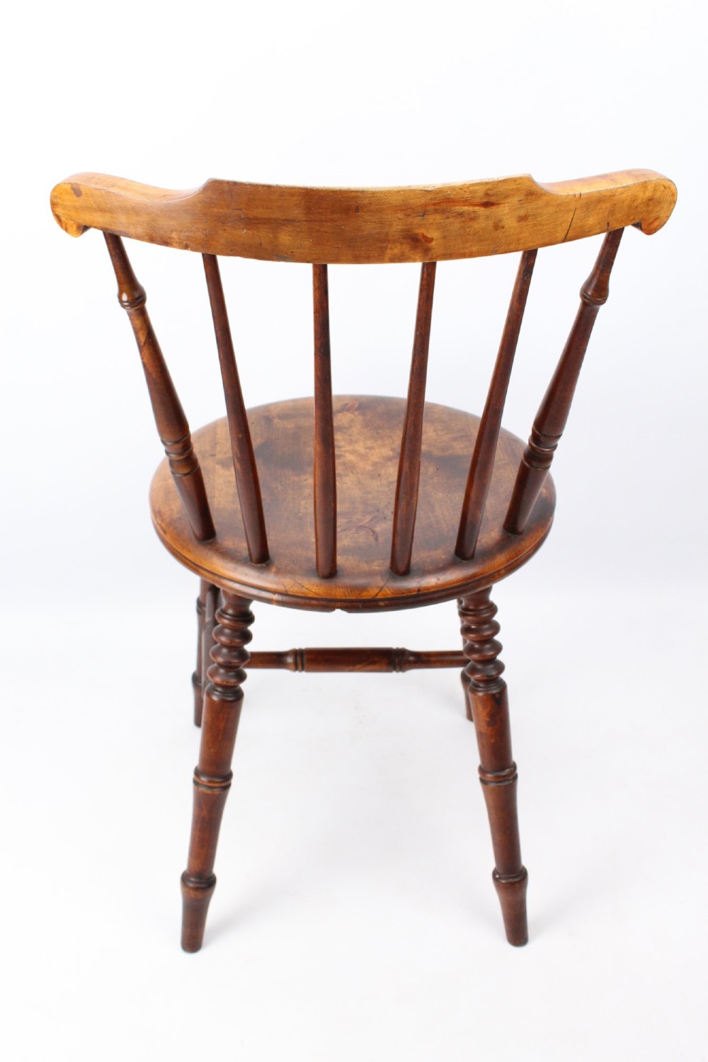 A pair of warm brown wooden kitchen chairs featuring spindle backs, turned legs, and solid timber seats. View V