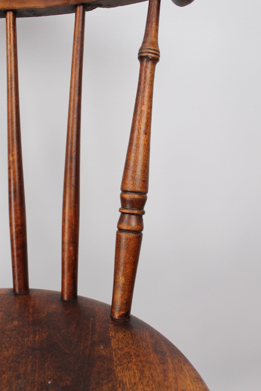 A pair of warm brown wooden kitchen chairs featuring spindle backs, turned legs, and solid timber seats. View XII