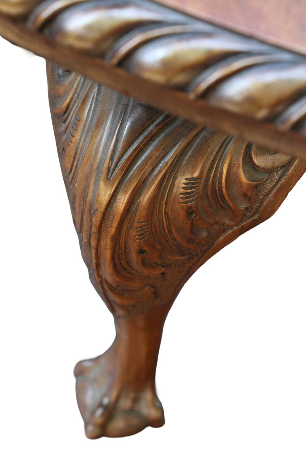 An antique Edwardian extending mahogany dining table featuring an oval top with gadrooned edges and carved cabriole legs terminating in ball-and-claw feet. View IX