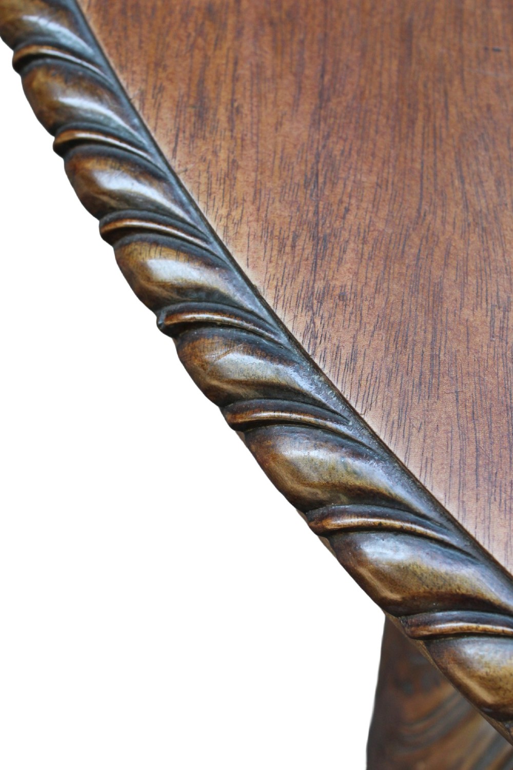 An antique Edwardian extending mahogany dining table featuring an oval top with gadrooned edges and carved cabriole legs terminating in ball-and-claw feet. View X