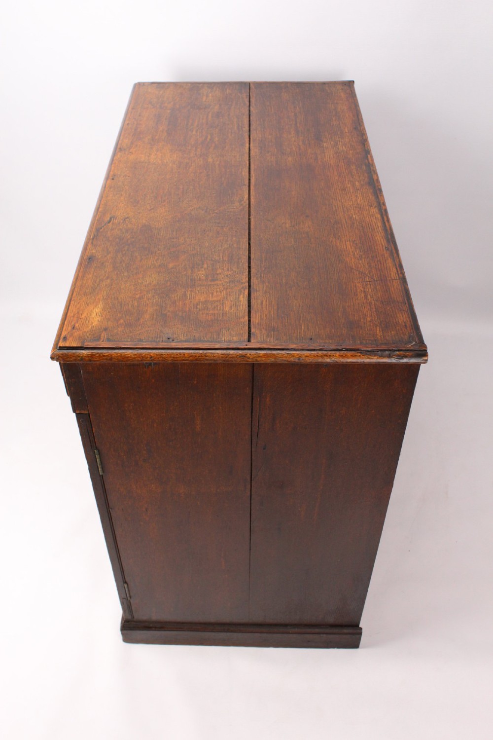 A low Georgian oak cupboard featuring two frieze drawers with turned wooden knobs above a pair of panelled cupboard doors. View V