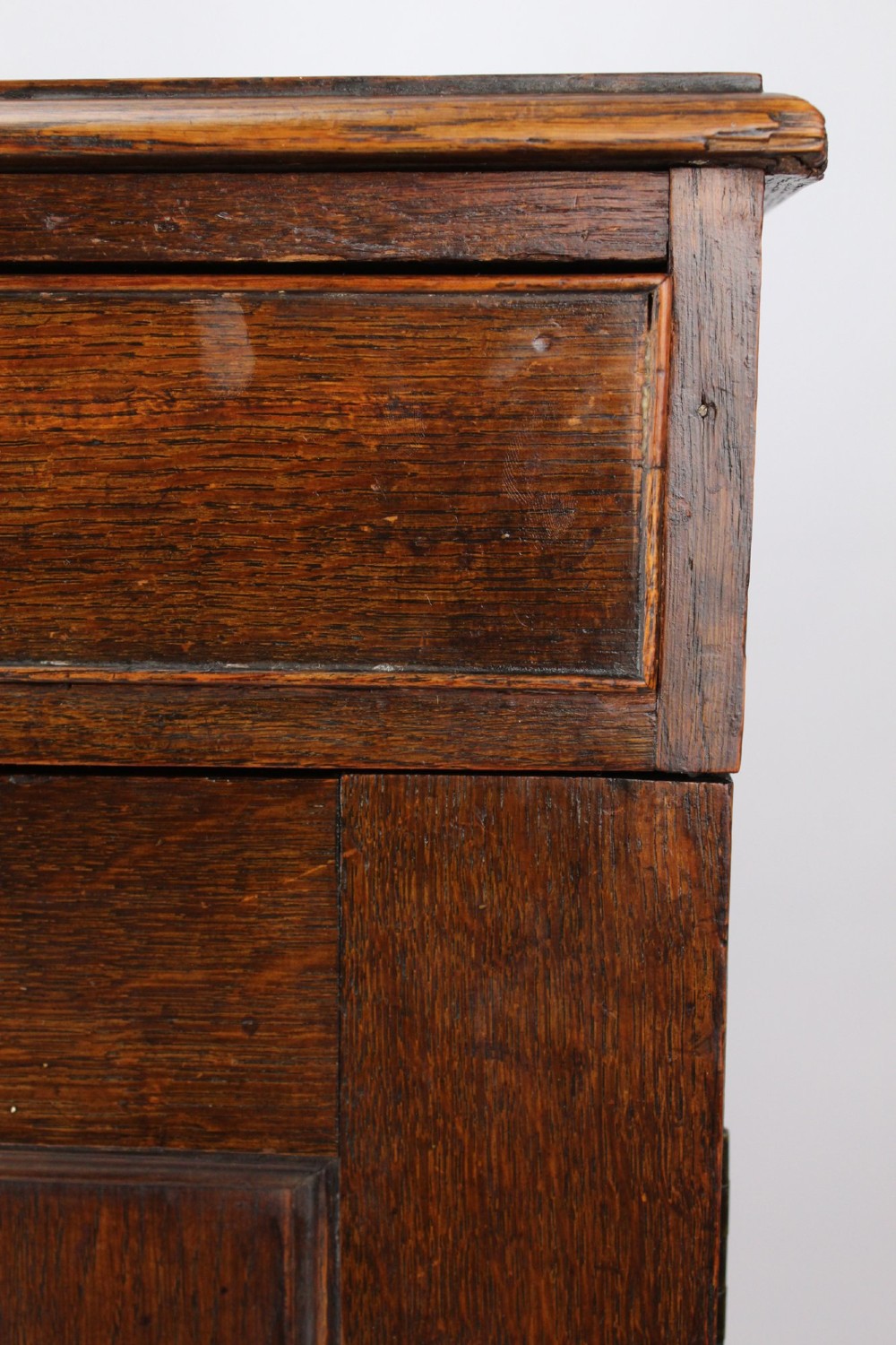 A low Georgian oak cupboard featuring two frieze drawers with turned wooden knobs above a pair of panelled cupboard doors. View XI