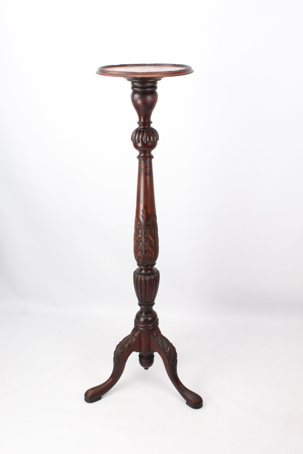 A tall Edwardian mahogany plant stand with a circular top, carved acanthus leaf column, and a tripod base. View III