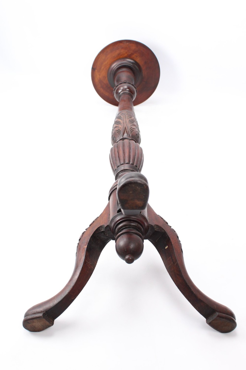 A tall Edwardian mahogany plant stand with a circular top, carved acanthus leaf column, and a tripod base. View XII
