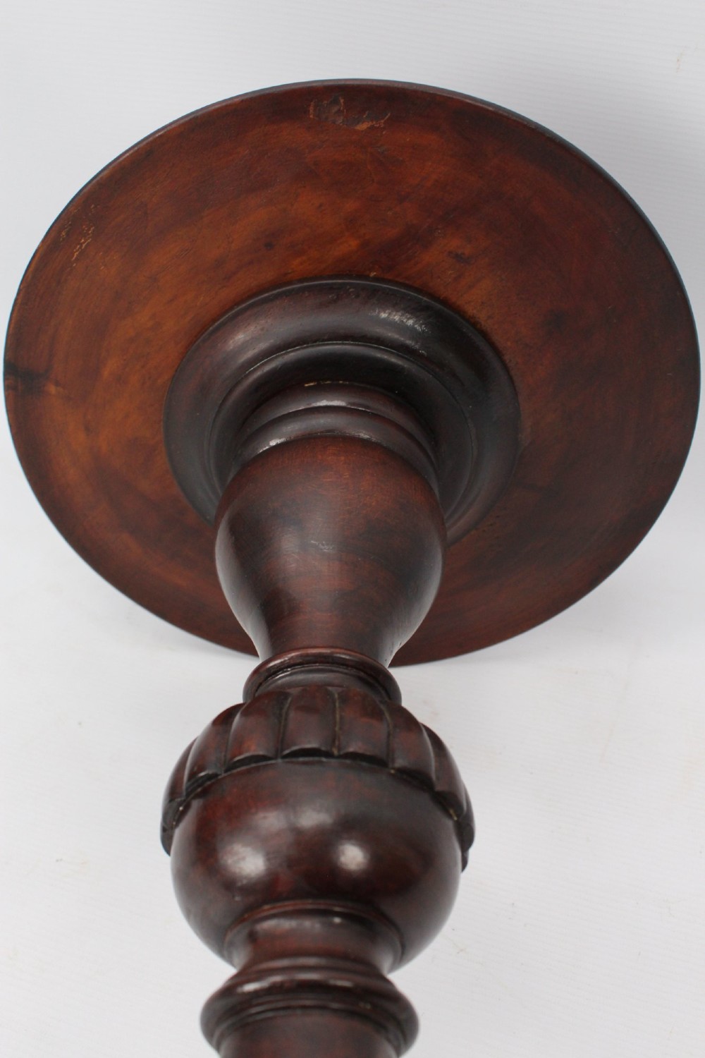 A tall Edwardian mahogany plant stand with a circular top, carved acanthus leaf column, and a tripod base. View XIII