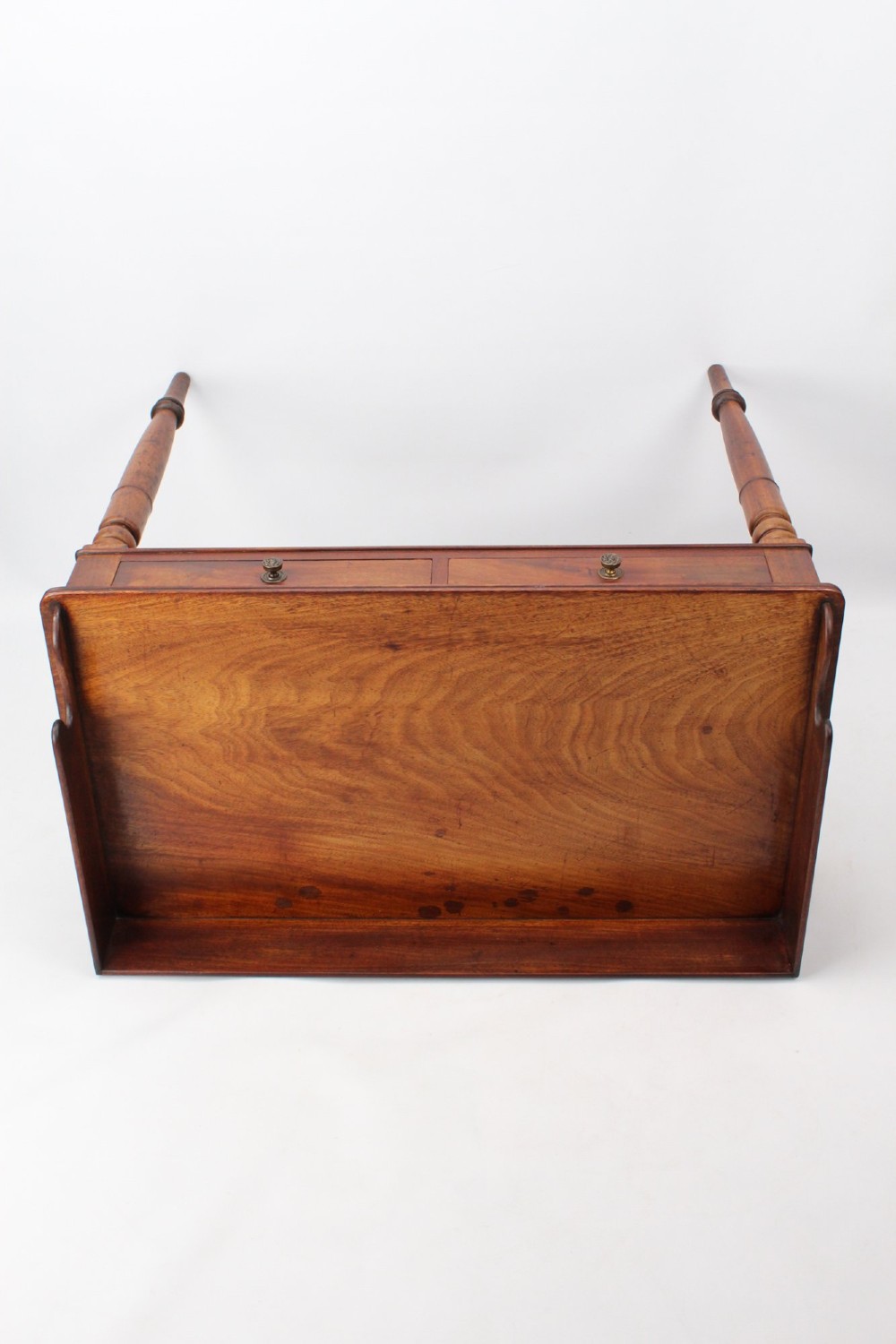 A Victorian mahogany writing table featuring a low gallery back top, two frieze drawers with decorative handles, and four turned legs. View V