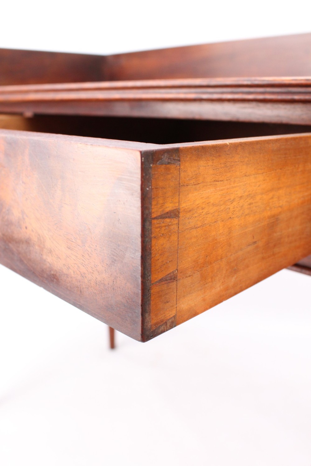 A Victorian mahogany writing table featuring a low gallery back top, two frieze drawers with decorative handles, and four turned legs. View VI