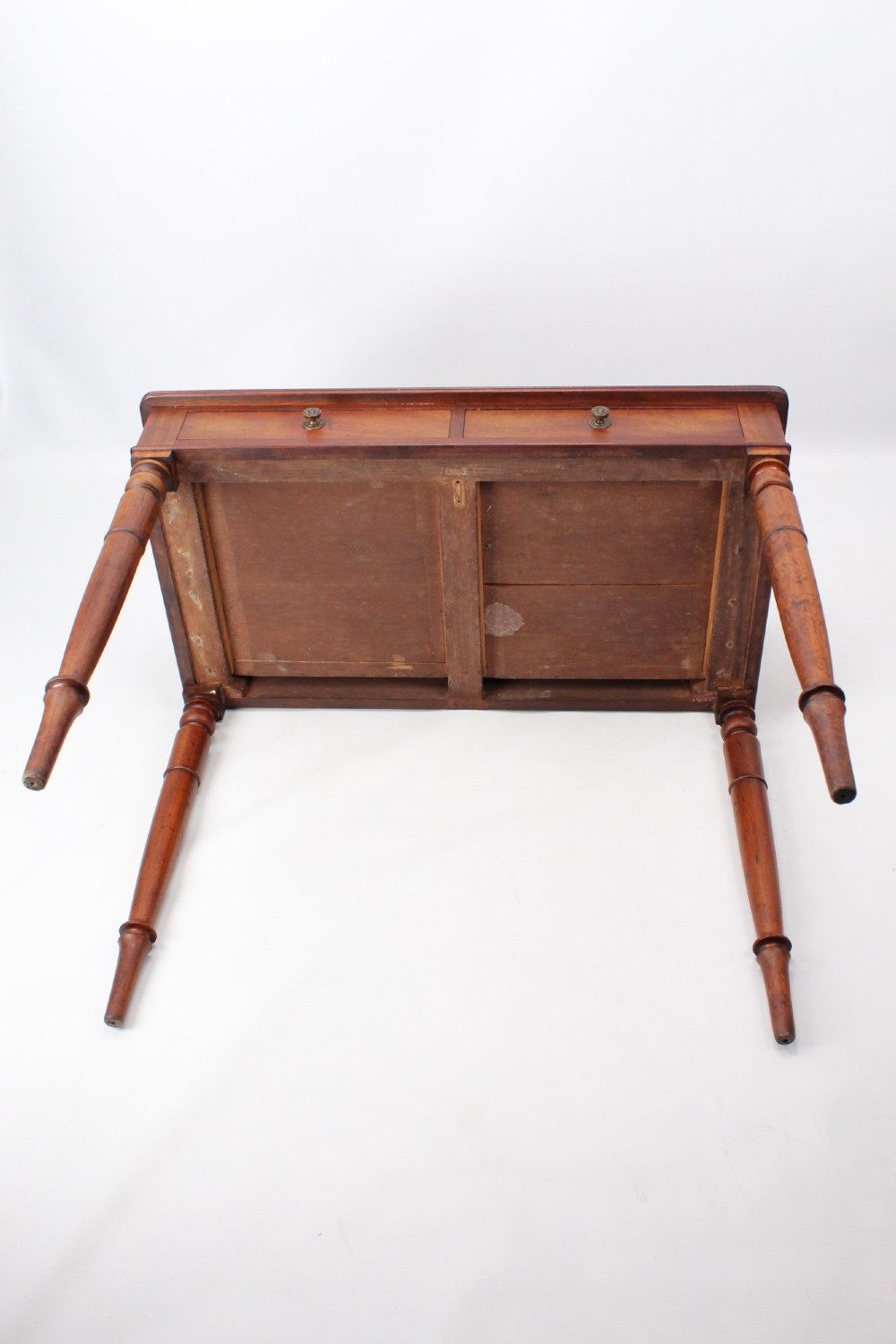 A Victorian mahogany writing table featuring a low gallery back top, two frieze drawers with decorative handles, and four turned legs. View XIII