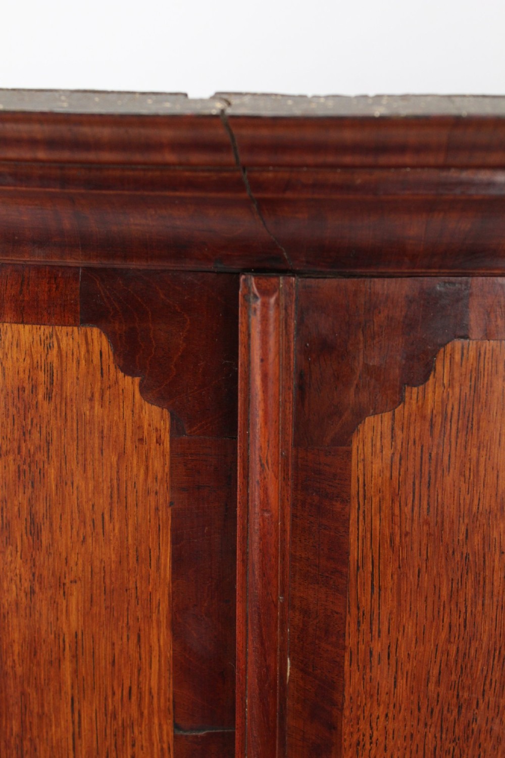 An 18th-century Georgian oak corner cupboard featuring a curved bow front, brass H-hinges, keyhole escutcheon plates, and mahogany crossbanding. View IX