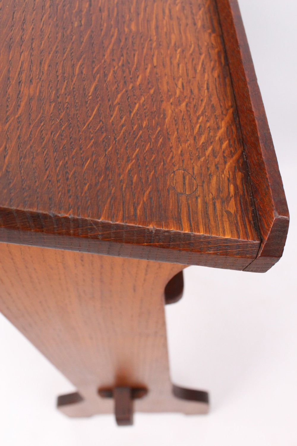 An Edwardian Arts and Crafts solid oak lectern featuring an angled reading top, an open middle shelf, and visible wedge tenon joinery. View IX