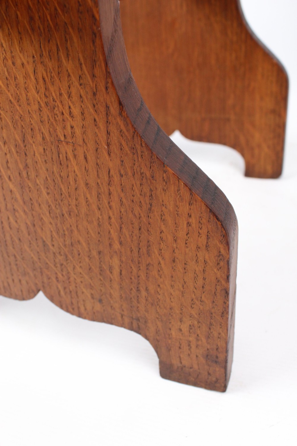 An Edwardian Arts and Crafts solid oak lectern featuring an angled reading top, an open middle shelf, and visible wedge tenon joinery. View XI