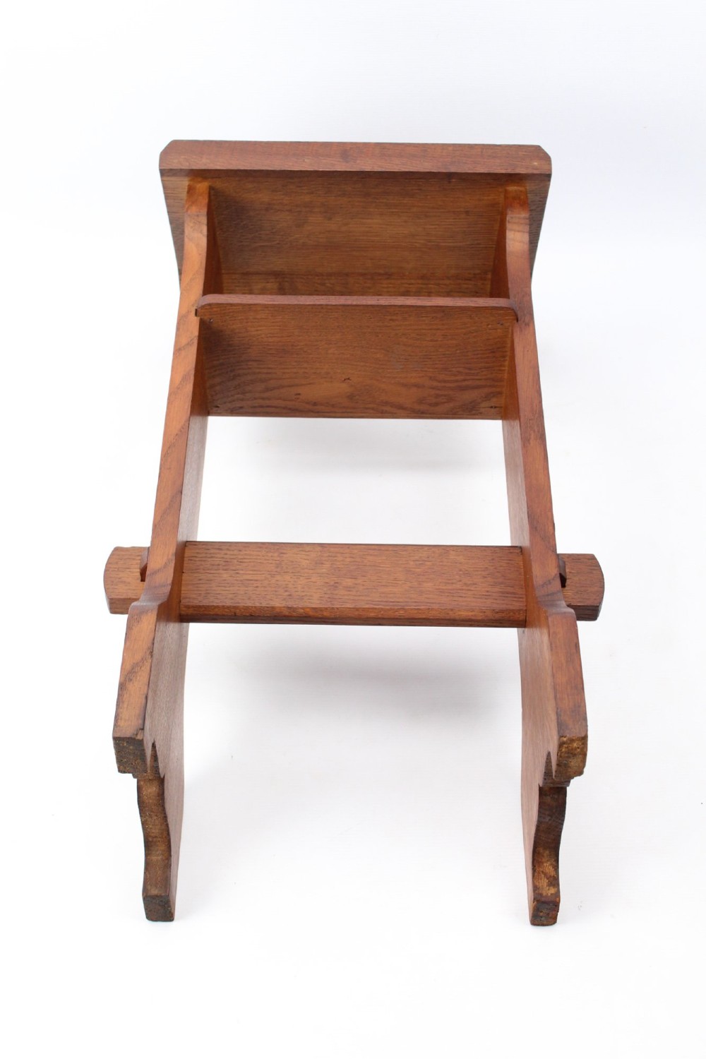 An Edwardian Arts and Crafts solid oak lectern featuring an angled reading top, an open middle shelf, and visible wedge tenon joinery. View XIII