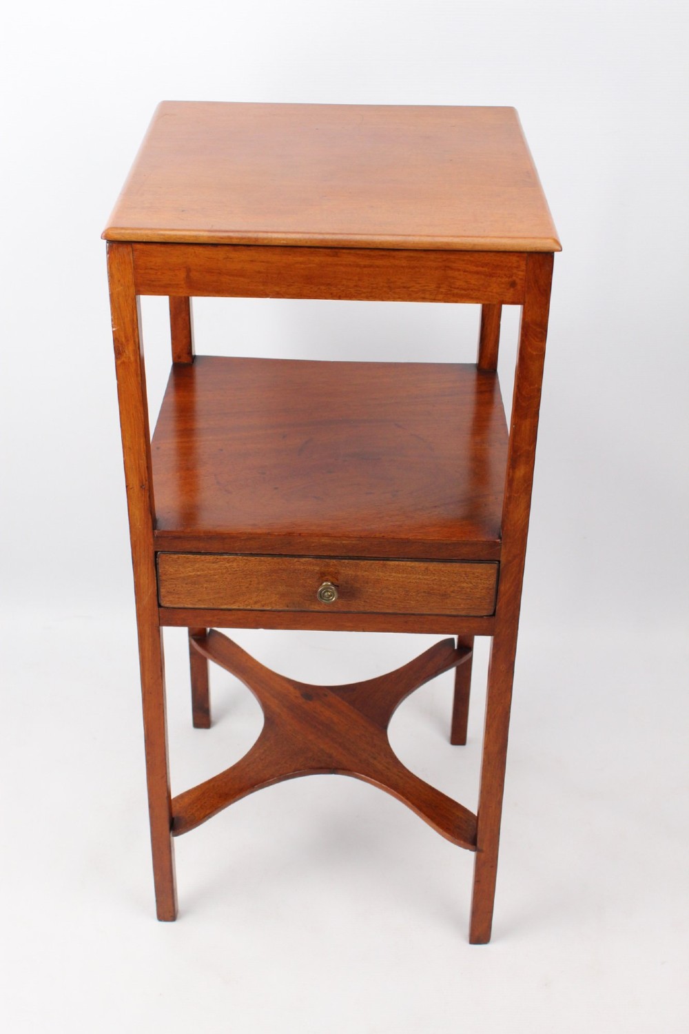 A two-tier Georgian mahogany bedside table with a single drawer, square top, and curved X-form stretcher. View III