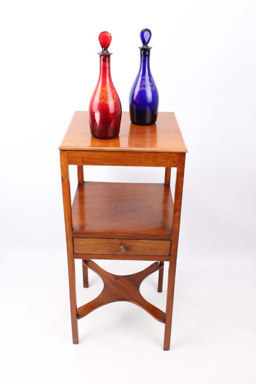 A two-tier Georgian mahogany bedside table with a single drawer, square top, and curved X-form stretcher. View VI